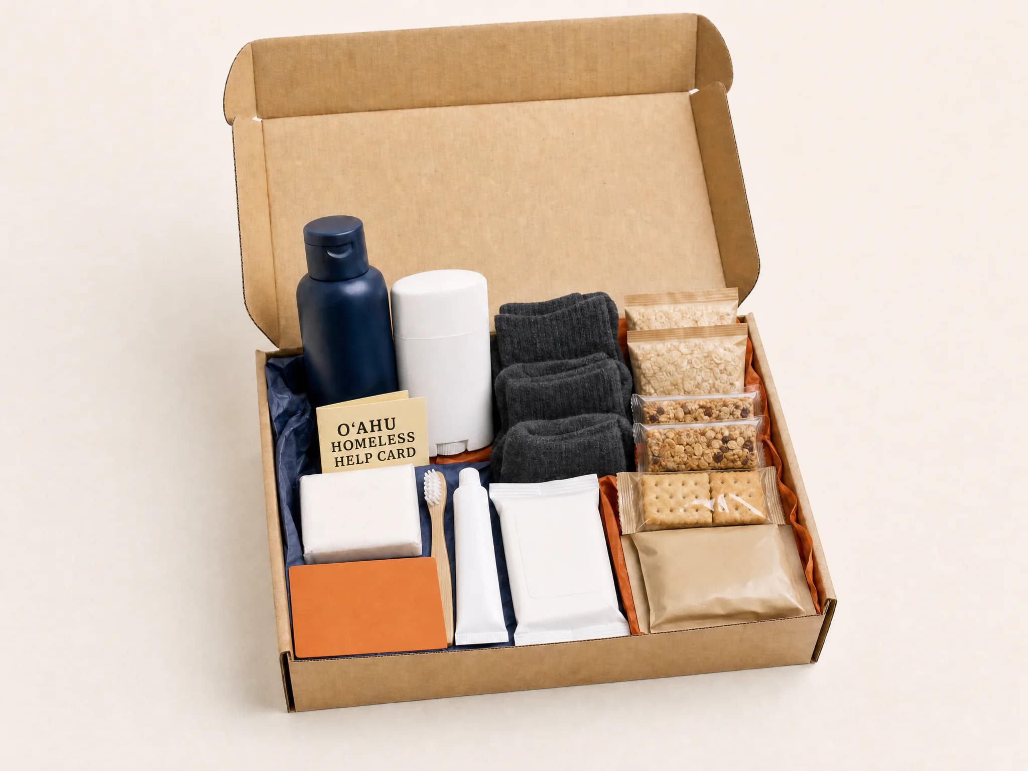 Open housing-transition kit with hygiene supplies, socks, packaged food, and a resource card.