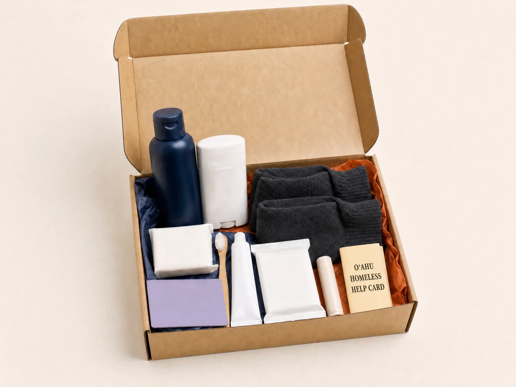 Open LGBTQ+ care kit with hygiene supplies, socks, lip balm, and an Oʻahu homeless help card.