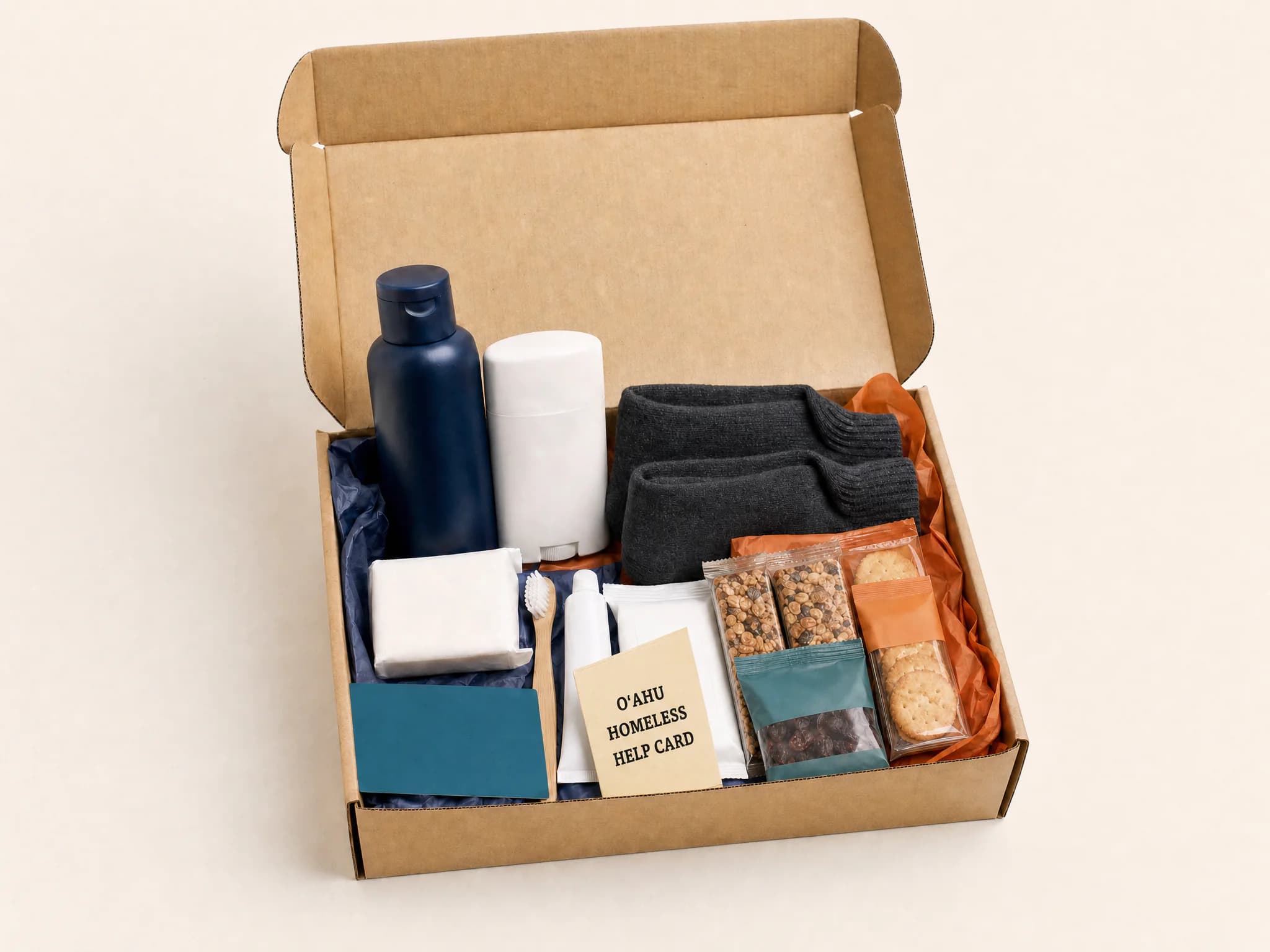 Open Youth care kit with hygiene supplies, socks, packaged snacks, and a resource card.